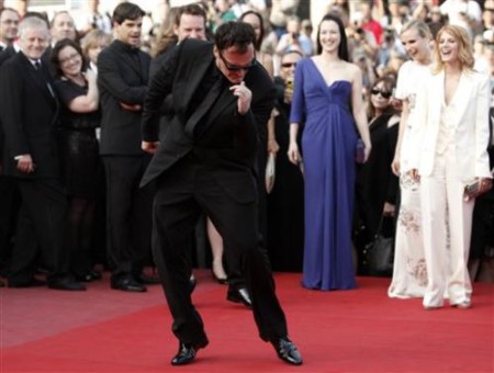 2134082894-american-director-quentin-tarantino-center-dances-as-he-arrives-on